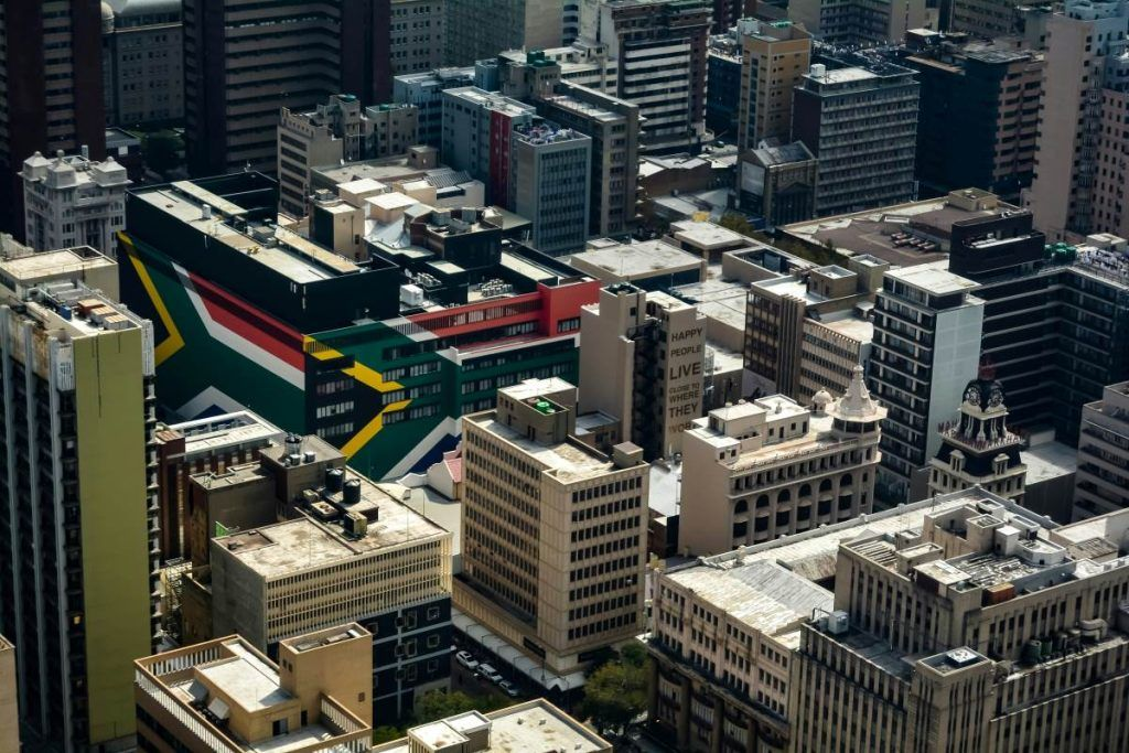 Aerial view of the Johannesburg inner city, a flag-painted building among the stock